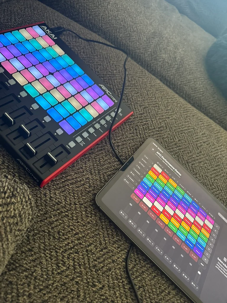 A colorful pad controller beside an iPad running Signal